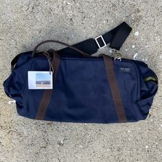 Size (Approx.): 20" L X 11" H X 9" D. Color: Navy Exterior / Olive Green Interior. Jack Spade Style: Nyru0053. Product Description (Per Jack Spade): Durable Canvas Exterior With Nylon Ripstop Interior Lining & Mesh Pockets. Zip Under Storage For Worn Gym Clothes. Double Handles For Easy Carrying. Detachable Adjustable Shoulder Strap. Zip Top Closure. Measures Approx. 20" L X 11" H X 9" D. Blue Satchel Travel Bag For Everyday Use, Everyday Blue Shoulder Travel Bag, Blue Shoulder Duffle Bag For Everyday Use, Blue Rectangular Travel Bag For Weekend Trips, Blue Rectangular Weekender Bag For Travel, Blue Everyday Shoulder Travel Bag, Blue Tote Duffle Bag For Weekend Trips, Blue Bags With Pockets For Weekend Trips, Blue Rectangular Bag For Weekend Trips