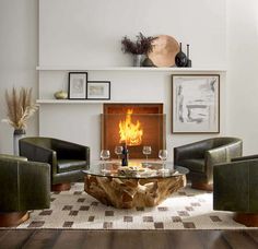 a living room filled with furniture and a fire place in the middle of the room