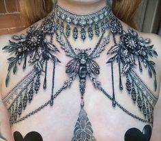 the back of a woman's chest is adorned with jewels