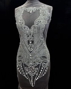 the back of a dress with beading on it