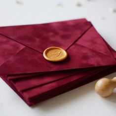 a red envelope with a wax stamp on it