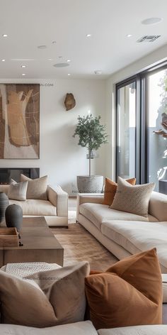 a living room filled with lots of furniture and a painting on the wall behind it