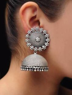 "Add charm and elegance to your to your beautiful personality with these exquisitely handcrafted oversized jhumkas in high quality German Silver. The silver antique look gives these jhumkas a very eye catching look and looks like real silver . Pair it up with any formal or casual attire and win compliments for a classy look. Earrings length 2.6\" Width 1.3\" Weight 70 gm Note: All in stock items will be shipped from New Delhi, India within 2-3 business days after receipt of payment. Internationa Silver Bohemian Dual-tone Jhumkas, Silver Dual-tone Bohemian Jhumkas, Bohemian Silver Dual-tone Jhumkas, Silver Dual-tone Temple Jewelry Jhumkas, Heavy Silver Metal Jhumkas, Bohemian Silver Earrings With Cutdana, Silver Bohemian Earrings With Cutdana, Silver Temple Jewelry Jhumkas For Navratri, Silver Cutdana Jhumkas For Navratri