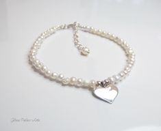 Fall in love all over again with this glimmering silver heart and pearl bracelet....................... White/ Ivory freshwater pearls are AA quality and measure about 2mm Shiny sterling heart measures about 13mm Chain is dainty 925 sterling silver Bracelet is adjustable (choose your size) Bracelet closes with a sterling silver spring clasp This is a handmade item and made for you after the order is placed Adjustable Silver Pearl Bracelet For Valentine's Day, Silver Heart-shaped Pearl Bracelet For Gift, White Heart-shaped Beaded Bracelets For Wedding, White Pearl Bracelet With Heart Beads, Elegant Pearl Heart Bracelet With Charm, White Heart-shaped Pearl Bracelet For Wedding, White Heart-shaped Bracelet For Weddings, White Heart Bracelet For Wedding, White Heart-shaped Wedding Bracelet