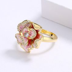 This Exquisite Pink Flower Enamel Ring is classified as Chinese Jewelry or as Art Nouveau Jewelry, which will add a touch of elegance. The Captivating Flower Design adorns your natural beauty, suitable for the occasions of Casual or Day Hangouts. Brightly Enamel is a classic choice to give as a gift or wear on life's most precious days. You can wear this Exquisite Pink Flower Enamel Ring on its own or partner with classic silhouettes for an which will add a touch of elegance pairing. TJ(trendyje Flower Shaped Cubic Zirconia Gift Ring, Flower Shaped Diamond Ring Gift, Diamond Enamel Gemstone Ring Gift, Diamond Enamel Ring With Gemstone For Gift, Gold Enamel Flower Ring For Anniversary, Floral Enamel Wedding Jewelry, Elegant Pink Enamel Ring, Elegant Crystal Flower-shaped Ring As Gift, Elegant Crystal Flower Ring As Gift