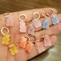 ⚡ ADD TWO OR MORE ITEMS TO THE CART AND ENJOY FREE EXPRESS SHIPPING ⚡ 🚀 DHL - FedEx - UPS (1-4 DAYS DELİVERY) 🚀 🧸 🐻 Stay being cute in GOLDx's gummy bear Huggie Earring, featuring a cute neon teddy candy bear pendant that dangles gracefully from a chic huggie. Wear this gem in an array of bright colors ranging from neon yellow to vibrant turquoise. Stack it up with a couple of studs and rock your favorite graphic tee for a lively vibe. ♡ Cute Gummy Bear Earrings Collection 🧸 🐻 Teddy Earrin Cute Gummy Bear, Gummy Bear Earrings, Jelly Bears, Bear Earrings, Huggie Earring, Color Earrings, Bear Pendant, Swarovski Stones, Earring Holder