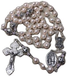 a rosary with an image of the virgin mary and jesus on it's side