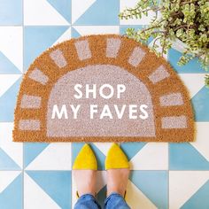 a person standing in front of a door mat with the words shop my faves on it