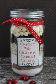 a jar filled with white chocolate and cranberry cookies