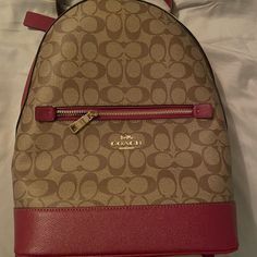 Brand New Coach Backpack. I Got It As A Christmas Gift And Gave No Use For It. There Are Zero Blemishes. It Unfortunately Wasn’t Gifted With The Duster Bag But I Have Photos Of The Authenticity Label In The Photos. The Price Is Just Based On What I Found Online. I Am Open To Reasonable Offers! Please Let Me Know If You Have Any Questions. I Will Ship Same Day If Before Noon Pst Or Next Day. Coach Bags | Nwot Coach Kenley Brown H2179-C5679 Signature Coated Canvas Backpack | Color: Red/Tan | Size: Red Leather Standard Backpack, Red Backpack With Removable Pouch, Chic Red Backpack Bag, Travel Backpack In Coated Canvas, Coated Canvas Travel Backpack, Coach Burgundy Bag With Zipper Closure, Coach Backpack, I Got It, Canvas Backpack