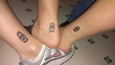 two people with matching tattoos on their feet