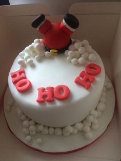 a white cake with red frosting that says ho ho ho