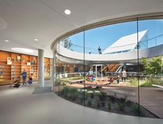 the interior of a library with people walking around