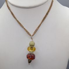 "Vintage Hand Beaded Crystal and Art Glass Drop Pendant on Gold Tone Chain Necklace, Smoky Brown and Gold Tones, Lots of Sparkle 20\" necklace; 2\" x 1/2\" pendant Condition * Very Nice Condition. Gently used. Size: Womens 20\" Condition: Pre-Owned Good" Czech Glass Beaded Chain Dangle Necklaces, Czech Glass Beaded Chain Dangle Necklace, Artistic Beaded Gold Jewelry, Artistic Gold Beaded Jewelry, Amber Multi-strand Beaded Necklace Gift, Amber Multi-strand Beaded Necklaces For Gift, Multi-strand Beaded Chain Necklace Gift, Beaded Chain Necklace Costume Jewelry For Gift, Unique Multi-strand Necklaces With Spacer Beads