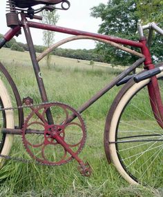 an old bicycle is sitting in the grass