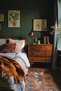 a bedroom with green walls and wooden furniture