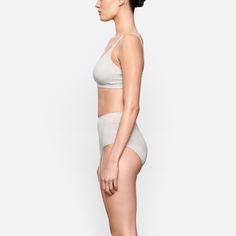 This is one bra you’ll never want to take off. In our ultra soft and lightweight jersey fabric, this scoop neck bralette features an elastic band and hook-free design for a comfortable fit. Perfect for layering or wearing on its own. | SKIMS Scoop Bralette | Grey | XS | Cotton Jersey Everyday Scoop Neck Fitted Bra, Fitted Scoop Neck Bra For Loungewear, Loungewear Stretch Nursing Bra With Soft Touch, Seamless Cropped Sports Bra For Loungewear, Seamless Sports Bra For Everyday, Loungewear Seamless Scoop Neck Bra, Seamless Sports Bra With Minimal Stretch, Scoop Neck Seamless Bra For Loungewear, Everyday Seamless Sports Bra With Minimal Stretch