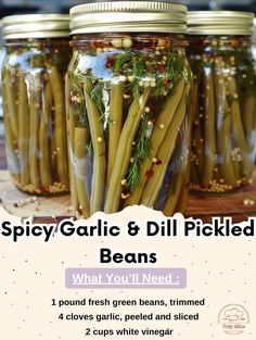 three jars filled with beans and herbs on top of a wooden table next to the words spicy garlic & dill pickled beans