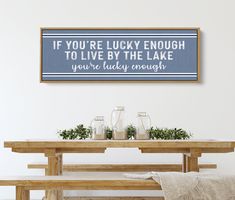 a blue and white sign that says if you're lucky enough to live by the lake, you're lucky enough