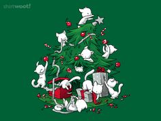 a green shirt with white cats around a christmas tree