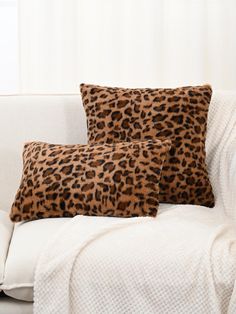 two leopard print pillows on a white couch