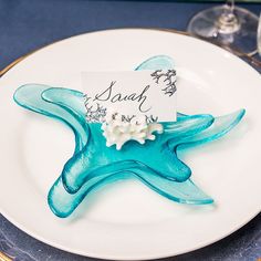 a white plate topped with a blue starfish