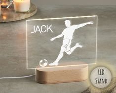 a light up acrylic with a soccer player on it