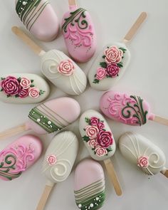 there are many pink and green decorated lollipops