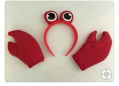 a pair of red mittens and gloves with googly eyes on white table top