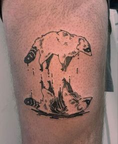 a man's leg with a bear and fish tattoo on the side of his calf