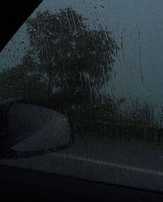 the rain is pouring down on the windshield