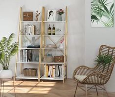 a living room with white walls and wooden shelves filled with books, vases and plants