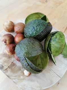 an avocado and other fruits on a plate