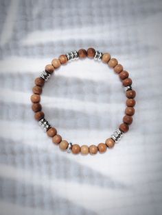 This stretchy fragrant sandalwood bead bracelet is sure to become a favorite. Designed to be gender inclusive, this classic Hawaiian bracelet is the new staple accessory.✦ DETAILS ✦✧ Name: Lanakila (lah-nah-KEE-lah) - victory.✧ 6mm sandalwood beads.✧ Silver plated base metal accents.✧ All Ke Aloha Jewelry pieces come packaged thoughtfully, beautifully, and ready for giving Mens Stretch Bracelets, Hawaiian Bracelets, Sandalwood Bracelet, Hawaii Gift, Hawaii Jewelry, Gender Inclusive, Metal Accents, Stretchy Bracelets, Metallic Accents