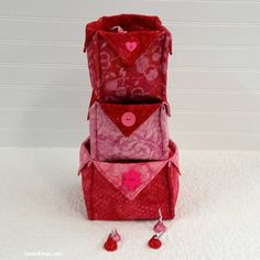 three bags are stacked on top of each other and one has hearts in the middle