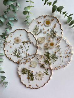 three plates with flowers and leaves on them