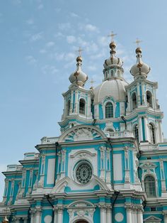 an ornate blue and white church with gold domes