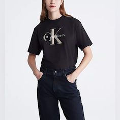 Women’s Calvin Klein Graphic Tee. Size:Medium Nwot Cut In A Boxy Fit, This T-Shirt Features A Ck Monogram Logo Design At The Front. Made With A Crewneck And Crafted From 100% Cotton For Comfortable Wear. Only Defect Is The Logo Has Black Writing On It & The Side Of The Shirt Has A Slit Hole. Measurements: Pit To Pit: 22” Shoulder To Hem: 25” Model Is 5'9" Wearing A Size S Final Sale / No Returns Calvin Klein Tshirt, Ck Monogram, White Calvin Klein, Black Writing, Monogram Logo Design, Crop Top Shirts, Calvin Klein Woman, Calvin Klein Black, Grey Shirt