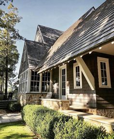 a brown house with white trim and windows