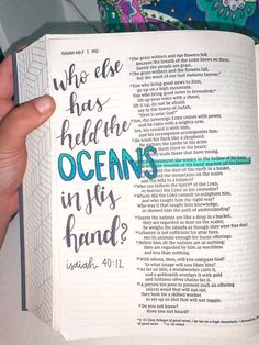 someone is holding an open bible with the words who else has heldhe oceans in his hand