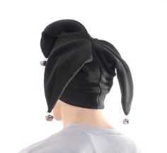 Three pointed jester hat made in black fleece. This is a joker style fools cap, one point in the front with two points to the rear side. Each of the point are tipped off with a silver jingle bell. Black double thick headband. One size fits most adults 22-24 inch heads. MG001630 Gothic Jester Outfit, Jester Hat Sewing Pattern, Jester Hat Pattern Sewing, Knitted Jester Hat, Mini Jester Hat, Thick Headband, Joker Halloween Costume, Halloween Costume Hats, Joker Halloween