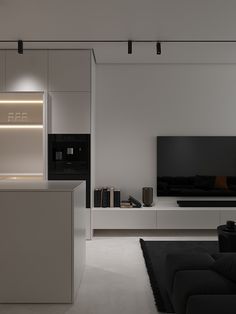 a living room filled with furniture and a flat screen tv mounted to the side of a wall