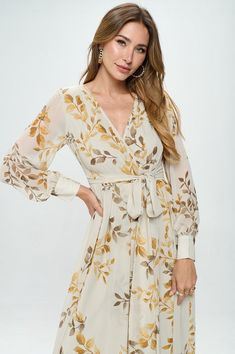 Introducing our stunning floral maxi dress. This dress features beautiful bubble sleeves and a flattering v-neckline, as well as a wrapped waist tie detail that helps create a stunning silhouette. The metallic threads and gold button details add an extra touch of glamour to this already stunning dress. The body of the dress is fully lined, ensuring both comfort and modesty, while the see-through sleeves add an elegant touch. The elastic waistband makes this dress perfect for expectant mothers, a Modest Tops, Metallic Thread, Pregnancy Photoshoot, Dress Floral, New Arrival Dress, Modest Dresses, Floral Maxi, Stunning Dresses, Pregnancy Photos