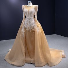 a dress on display in a room with dark walls and floor to ceiling carpeting