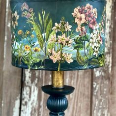 a blue lamp with flowers painted on it