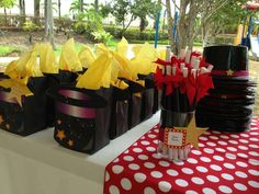 some black bags with yellow and red stars on them are sitting on a white table