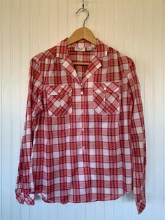 "NEW with original tags! Vintage Plaid Long Sleeve button up shirt Size 14 / Large - White Blue Red and Coral Plaid. Puff sleeves. Front pockets on chest. Autheintic vintage deadstock from the early 80s, New With Tags! Brand - Amy Barr 60% Cotton 40% Polyester Machine Washable Made in China Condition - Original Deadstock from the 80s, New With Tags Vintage Size - 14 Fits Like - large can fit smaller sizes with looser fit (see measurements) Measurements (Seam to seam, lying flat) - Bust* - 40\" W Plaid Long Sleeve Shirt With Placket, Long Sleeve Plaid Shirt With Placket, Plaid Top With Button Closure And Spread Collar, Plaid Top With Spread Collar And Button Closure, Plaid Collared Shirt With Placket, Collared Plaid Shirt With Placket, Plaid Cotton Collared Blouse, Red Collared Blouse With Pockets, Casual Red Blouse With Pockets