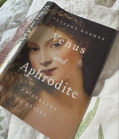 the book venus and aphrodite is laying on a bed