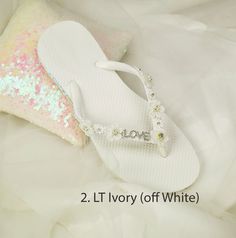 Wedding Lt Ivory Shoes,Bridal Flip Flops,Beach Wedding Shoes,Bridesmaid Slippers ,Floral Wedding Sandals, Rhinestone Flip Flops -SD047 We made with white flat flip flop decorated with Off white Flower .It is shining with a clear crystal on the lace. These flip flops are designed for brides and bridesmaids looking for style. Model shoe size US 8. Quantity:one order is 1 pair (2 pcs). Summer White Bridal Accessories For Bridal Shower, White Summer Bridal Accessories For Bridal Shower, Summer Bridal Accessories For Bridal Shower, White Bridal Accessories For Summer Bridal Shower, White Sandals With Rhinestones And Adjustable Fit, White Open Toe Flip Flops For Wedding, Elegant Rhinestone Flip Flops For Wedding, Elegant Wedding Flip Flops With Rhinestones, White Adjustable Flip Flops For Wedding