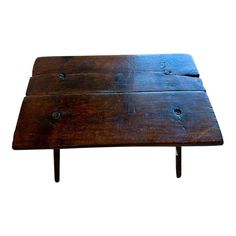 an old wooden table with nails on the top and legs, isolated against a white background